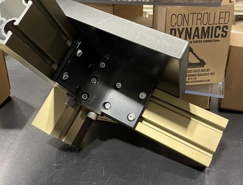 automated machinery enclosure manufacturing - corner bracket fastened to structural aluminum